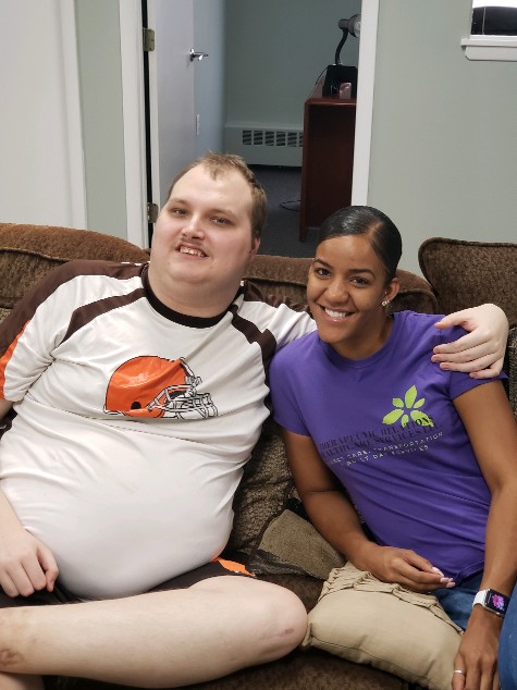 two people sitting on couch two people sitting on couch